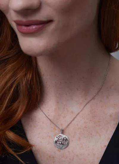Close up shot of red haired model wearing Sterling Silver Children Of Lir Pendant 